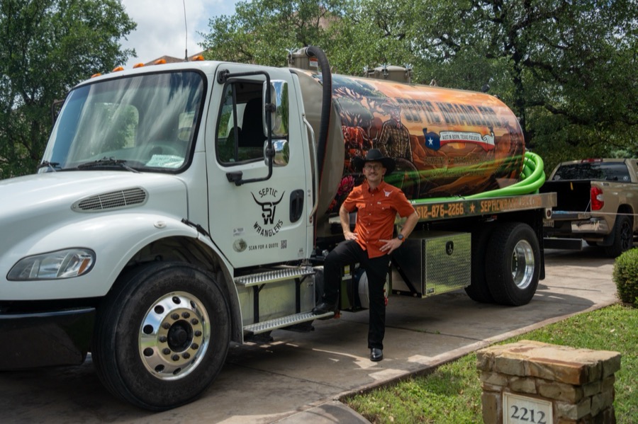 Jeff Uskirt, owner of Septic Wranglers, in front of his Freightliner septic truck in Austin, Texas
